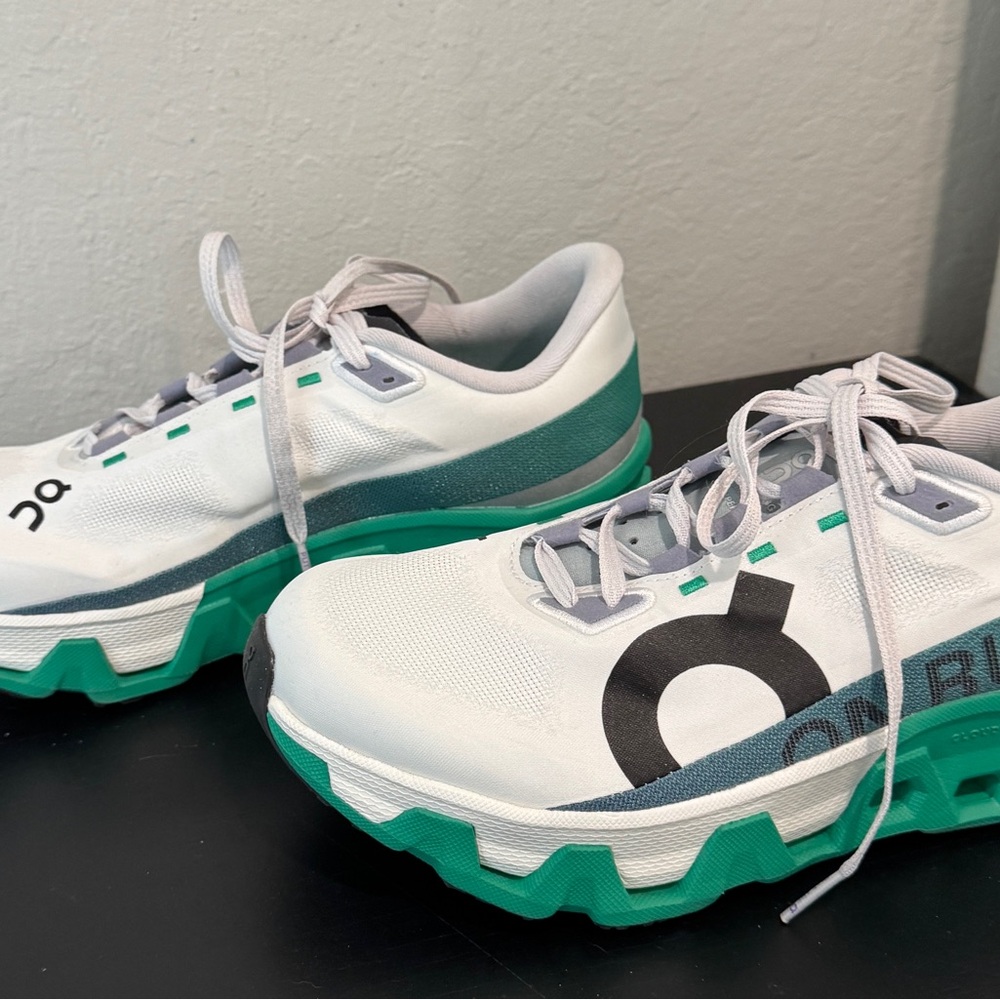 On Running White and Green Athletic Shoes with Cushioned Sole